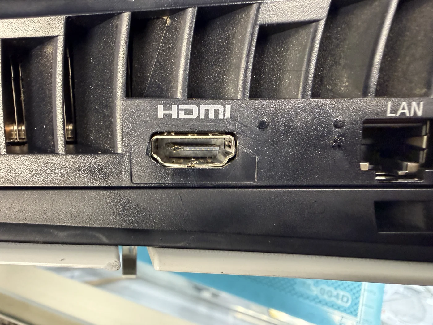 Close-up of the PS5 Slim HDMI port from outside, with bent and broken pins visible inside the socket