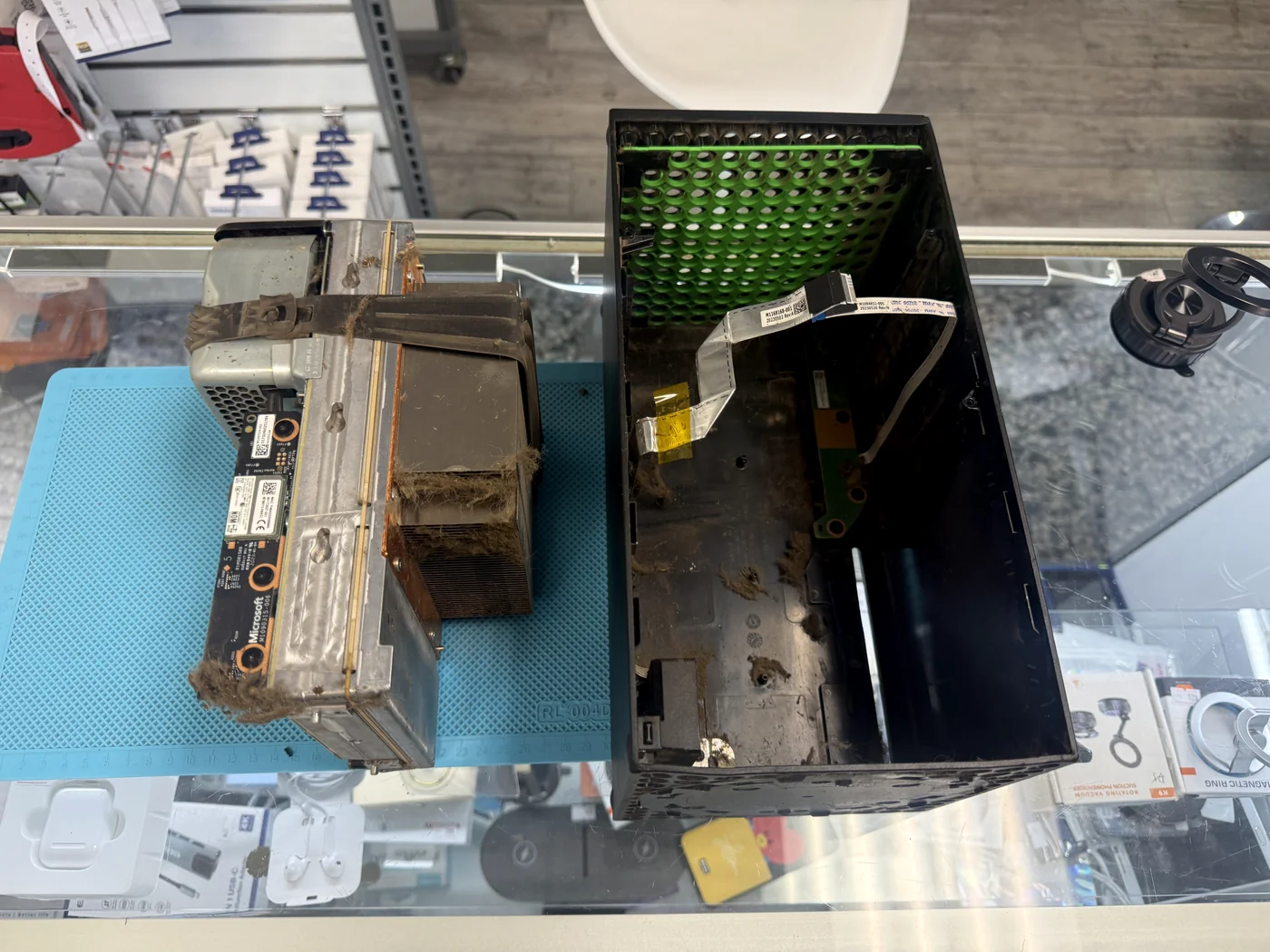 Xbox Series X chassis pulled from its shell with pet hair and debris inside