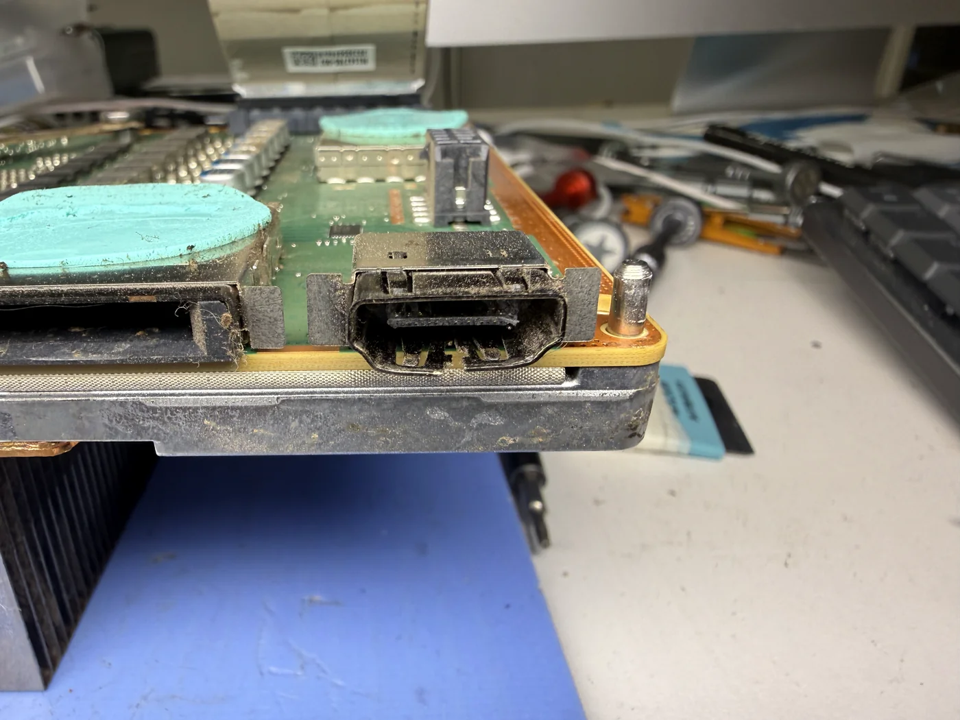 Grimy original HDMI port on the Xbox Series X mainboard before replacement