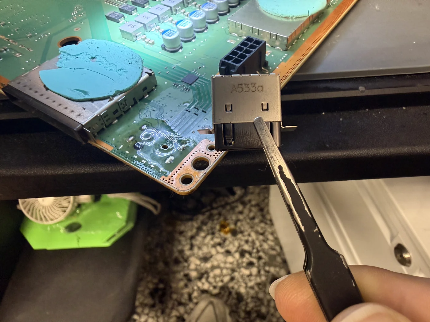 New HDMI port being aligned on the Xbox Series X board with tweezers